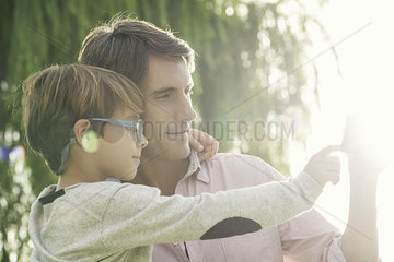 Father and son embracing outdoors  overexposure