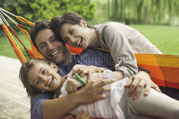 Family playing on hammock