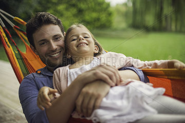Father and daughter together in hammock