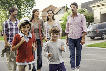 Family walking together through suburban neighborhood