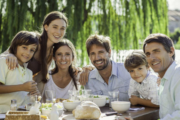 Family enjoying breakfast together outdoors  group portrait