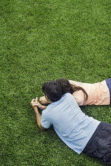 Couple lying together on grass