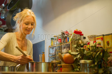 Mature woman cooking at home