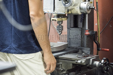 Factory worker using drill