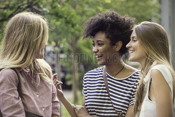 Young women laughing together outdoors