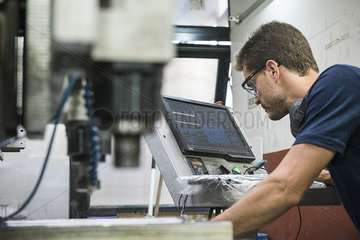 Machinist working in factory