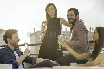 Friends drinking champagne together outdoors