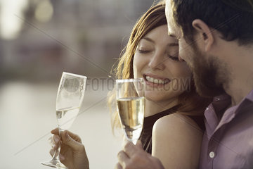 Couple celebrating with champagne outdoors