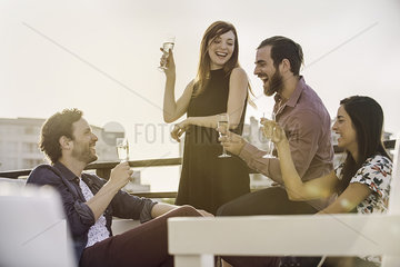 Group of friends relaxing with wine outdoors