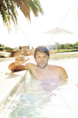 Man relaxing in pool  portrait