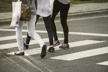 Women walking in crosswalk  low section