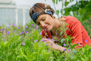 Woman smelling flowers in garden
