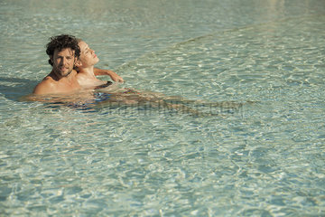 Couple relaxing together in pool