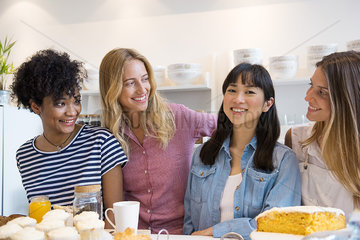 Young women smiling together in cafe