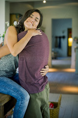 Couple embracing in kitchen