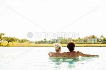 Couple relaxing together in lake  rear view