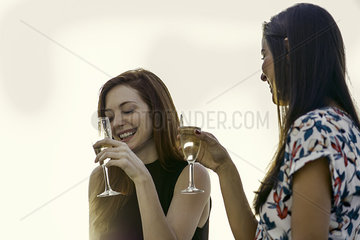 Woman drinking champagne together outdoors