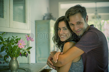 Couple embracing at home