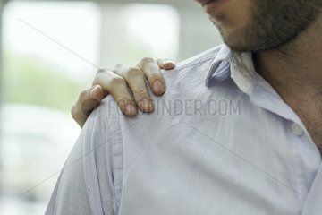 Healthcare worker's hand on patient's shoulder