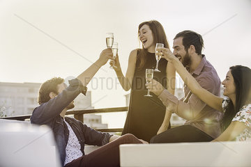 Group of friends relaxing with wine outdoors