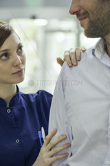 Doctor examining patient's shoulder