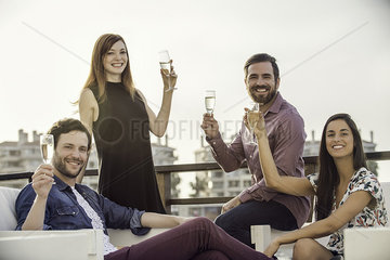 Friends drinking champagne together outdoors