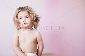Little girl sitting in diaper  portrait