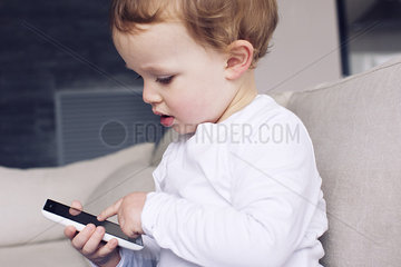 Little boy playing with smartphone