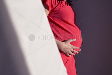Pregnant woman with hands on stomach  cropped