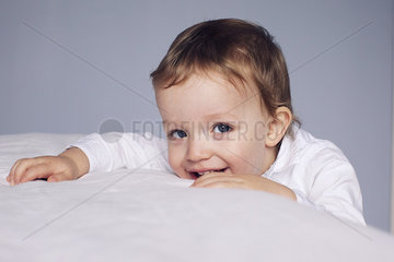 Little boy resting head on bed  portrait