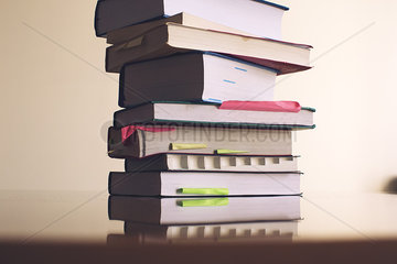 Textbooks stacked on table
