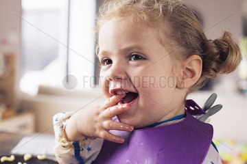 Little girl with fingers in mouth