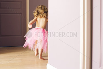 Little girl running in tutu  rear view
