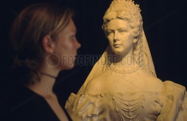 Frau steht vor Sissi -Skulptur