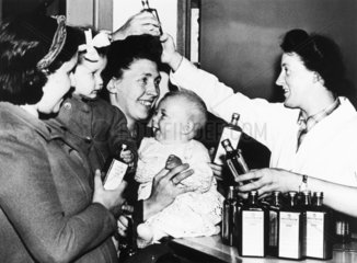 Mothers receiving American provisions  World War Two  12 March 1942.