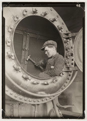 Man in a firebox  c 1925.