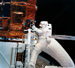 Shuttle astronaut with Solar Maximum Satellite  1984.