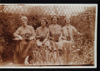 Four women with Kodak cameras  including Brownie cameras  c 1900s.