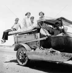 Migrant family travelling across the desert on US Highway 70  May 1937.
