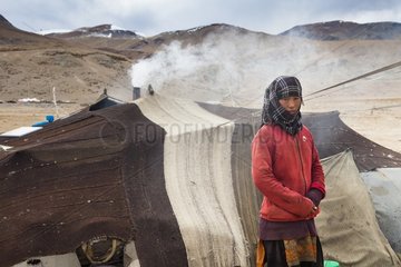 Young woman in front of tent in camp  Surroundings of Korzok  Leh  Ladakh  Himalayas  India