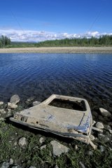 Door of car at the edge of a river Yukon Canada