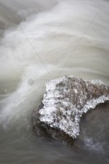 Flowing water & ice in a frozen stream Alps mass France