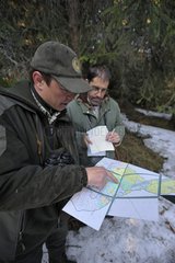Ranger and biologist reading a map Pospady