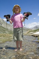 Barefoot girl in a torrent Queyras Alps France