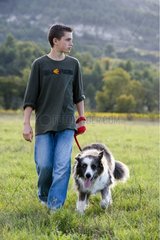 Young boy walking unt old dog in the countryside France