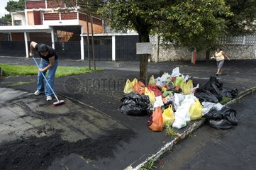 Street cleaning after eruption of Pacaya volcano Guatemala