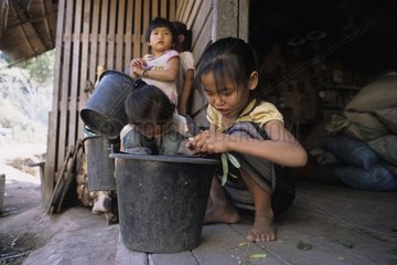 Young girls preparing the meal close to Luang Prabang Laos