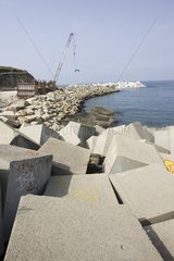 Constructing new breakwater outside harbour Puerto de Vega