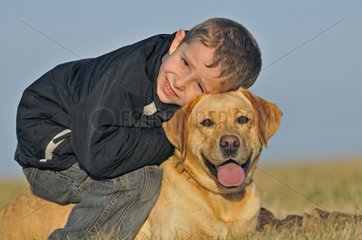 Portrait of a young boy and his Labrador dog