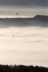 Balloon above the clouds at daybreak France